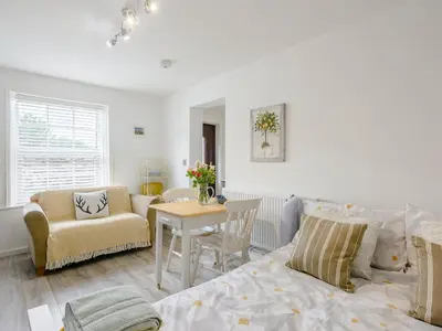a living room with a bed and a table at The Gardens in Santon