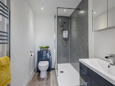 a bathroom with a shower and a toilet and a sink at The Gardens in Santon