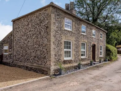 an old stone building with plants in front of it at The Gardens in Santon