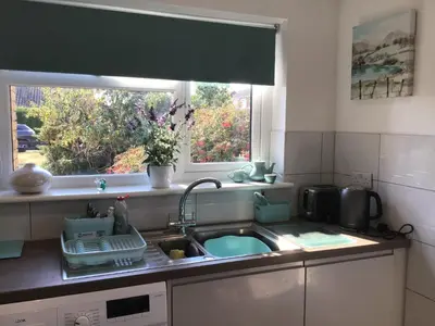 a kitchen with a sink and a window at Westbury House in Rochford