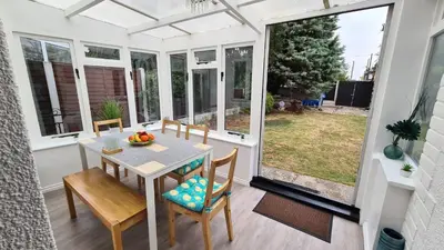 a dining room with a table and chairs at Westbury House in Rochford
