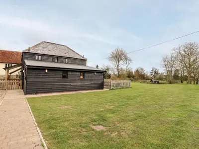 a house with a large yard in front of it at The Cart Lodge in Halstead