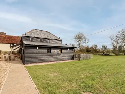 an image of a house with a yard at The Cart Lodge in Halstead