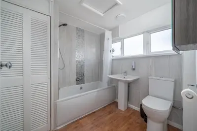 a white bathroom with a toilet and a sink at Skyvillion-STEVENAGE Amazing 3Bed House, Garden, Free Off Street Parking for 2 Cars, WiFi in Stevenage