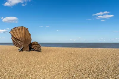 a shell in the sand on a beach at Alexander House in Thorpeness