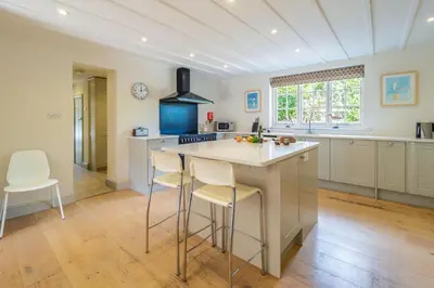 a kitchen with a large island in the middle of a room at Alexander House 4 in Thorpeness
