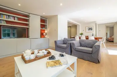 a living room with two chairs and a table at Alexander House 6 in Thorpeness