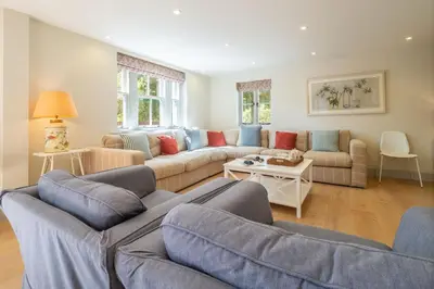 a living room with two couches and a table at Alexander House 6 in Thorpeness