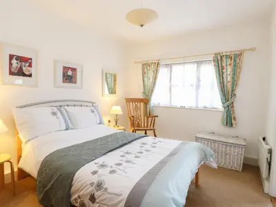 a bedroom with a bed and a window at Flink's Barn in Great Dunmow
