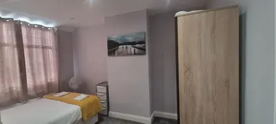 a bedroom with a bed and a mirror at Breeze on Southend in Essex in Southend-on-Sea