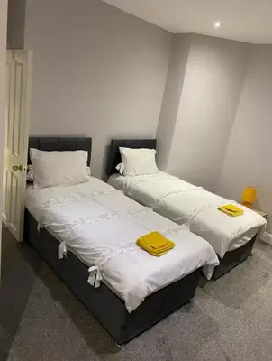 two beds sitting next to each other in a room at Breeze on Southend in Essex in Southend-on-Sea