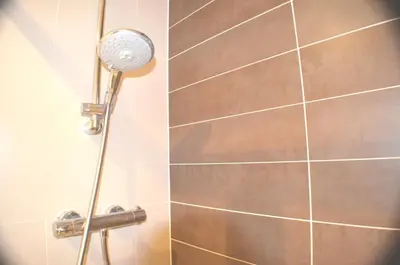 a shower with a shower head in a bathroom at 360 Serviced Accommodations - Brentwood 2 Bedroom Executive Apartment with Secure Parking in Brentwood