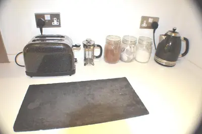 a kitchen counter with a toaster and jars on it at 360 Serviced Accommodations - Brentwood 2 Bedroom Executive Apartment with Secure Parking in Brentwood