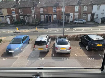 a group of cars parked in a parking lot at Toothbrush Apartments - Central Ipswich - Nr Train Station in Ipswich