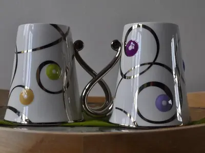 two coffee mugs sitting on top of a table at Chequer Cottage in Horseheath