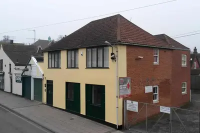 a yellow and green building on the side of a street at Stunning Apartment with Courtyard Near The Waterfront Ipswich in Ipswich