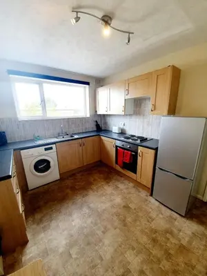 a kitchen with a refrigerator and a dishwasher at Rayleigh Town Centre 3 Bedroom Apartment in Rayleigh