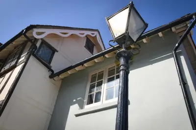a street light in front of a white house at The Gate Cottage in Thaxted
