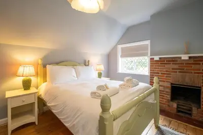 a bedroom with a bed with towels on it at 1 Westgate in Thorpeness