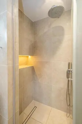 a bathroom with a shower with a glass door at 1 Westgate in Thorpeness