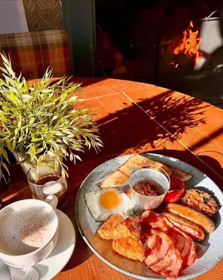 a plate of food with eggs and toast on a table at Three Tuns Ashwell in Ashwell