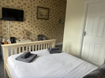 a bedroom with a bed with towels on it at Three Tuns Ashwell in Ashwell