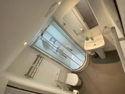 a small bathroom with a sink and a window at Comfortable cosy double ensuite room 'Karibu' in Cherry Hinton