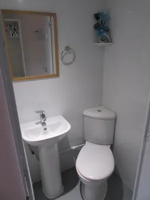 a bathroom with a white toilet and a sink at Independent two bed en-suite annex, close to city in Cambridge