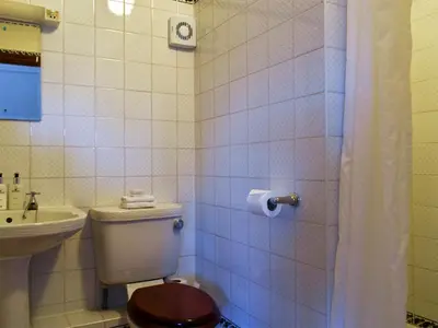 a bathroom with a toilet and a sink at The Old Bakery in Pulham Saint Mary Magdalene