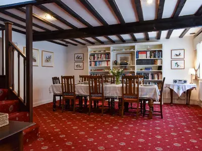 a dining room with a table and chairs at The Old Bakery in Pulham Saint Mary Magdalene