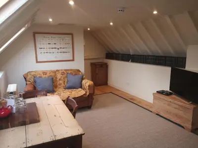 a living room with a couch and a table at The Queen's Head in Hawkedon