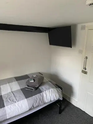 a bedroom with a bed in a room with a wall at The Ram Inn in Brandon