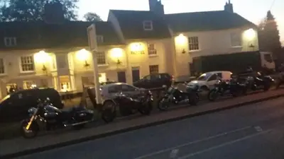 a row of motorcycles parked in front of a building at The Ram Inn in Brandon