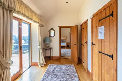 a hallway with a door to a room at Doves Barn in Needham Market