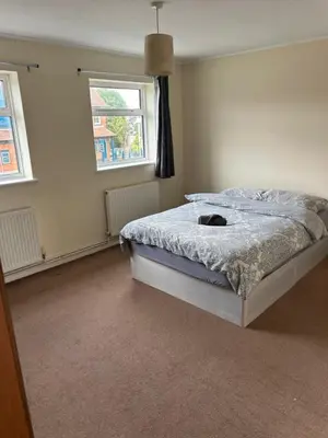 a bedroom with a bed and a window at 3 Bedroom Thundersley Apartment in Rayleigh