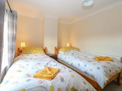 two beds sitting next to each other in a bedroom at Rose Cottage in Stoke Ferry
