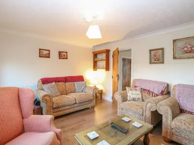 a living room with two couches and a coffee table at Rose Cottage in Stoke Ferry