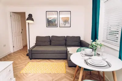 a living room with a couch and a table at Caroline Court - 1 Bedroom Apartment in Colchester