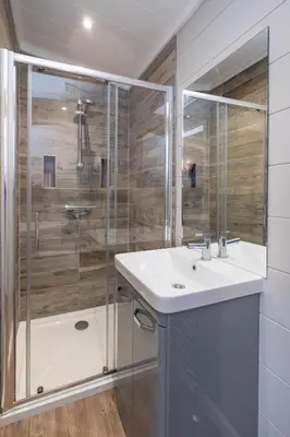 a bathroom with a sink and a shower at Savannah Lodge - Aldeburgh Coastal Cottages in Sizewell