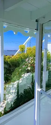a window with a view of a field of flowers at Beachfront Studio Apartment in Felixstowe