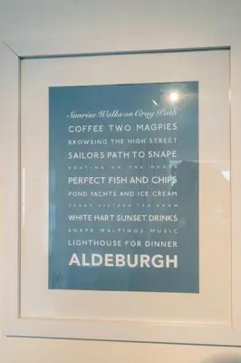 a framed picture of a sign in a window at April Cottage, Aldeburgh - Close to Aldeburgh beach and High Street - Managed by Aldeburgh Coastal Cottages in Aldeburgh
