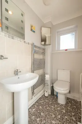 a bathroom with a sink and a toilet at April Cottage, Aldeburgh - Close to Aldeburgh beach and High Street - Managed by Aldeburgh Coastal Cottages in Aldeburgh