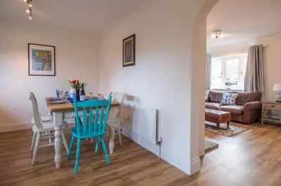a kitchen and dining room with a table and chairs at April Cottage, Aldeburgh - Close to Aldeburgh beach and High Street - Managed by Aldeburgh Coastal Cottages in Aldeburgh