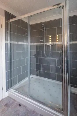 a shower with a glass door in a bathroom at April Cottage, Aldeburgh - Close to Aldeburgh beach and High Street - Managed by Aldeburgh Coastal Cottages in Aldeburgh