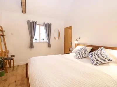 a bedroom with a bed with two pillows on it at The Duck House in Thetford