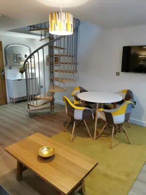 a living room with a table and chairs at The Barn in Swaffham