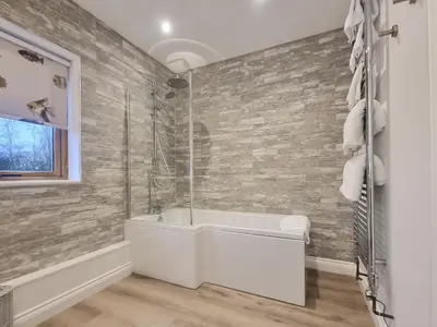 a bathroom with a tub and a glass shower at Mac Shack Cottage - Uk32376 in Ovington