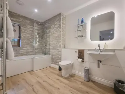 a bathroom with a toilet and a sink and a shower at Mac Shack Cottage - Uk32376 in Ovington