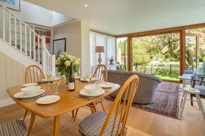 a dining room with a table and chairs at Gothic House Cottage in Clare