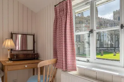 a room with a window with a desk and a mirror at Gothic House Cottage in Clare